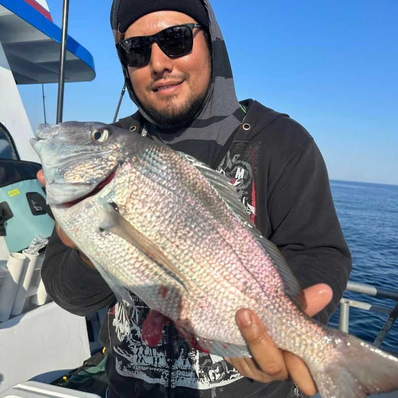a man holding a fish