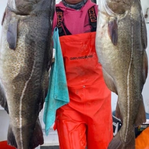 a person holding a fish