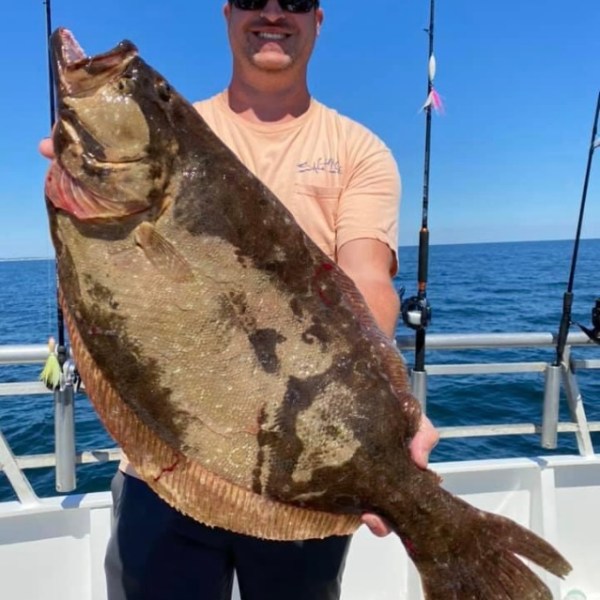 a person holding a fish in the water