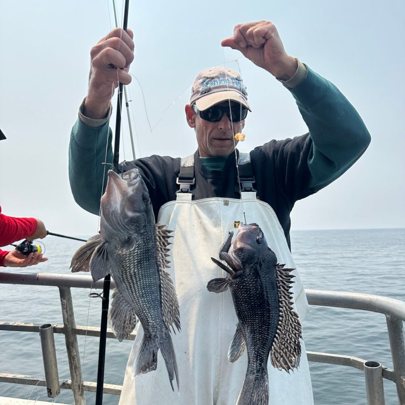 a person standing next to a body of water