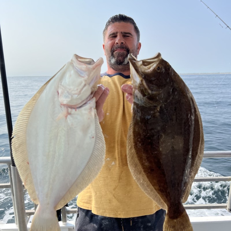 a man holding a fish in the water