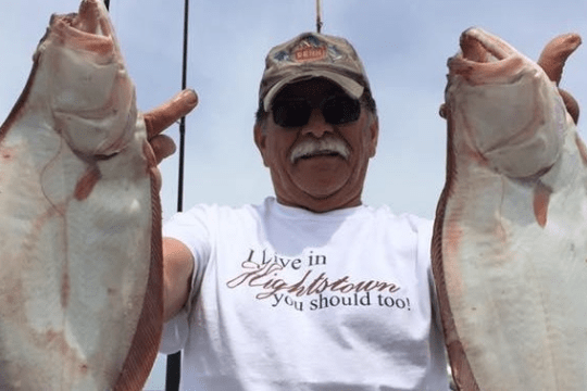 a man holding a fish