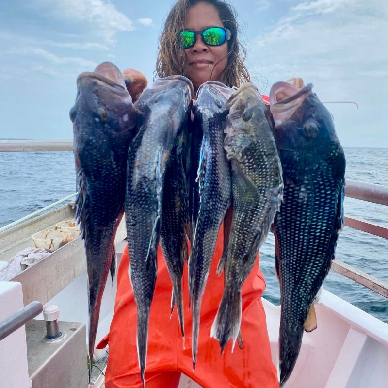a person holding a fish in the water